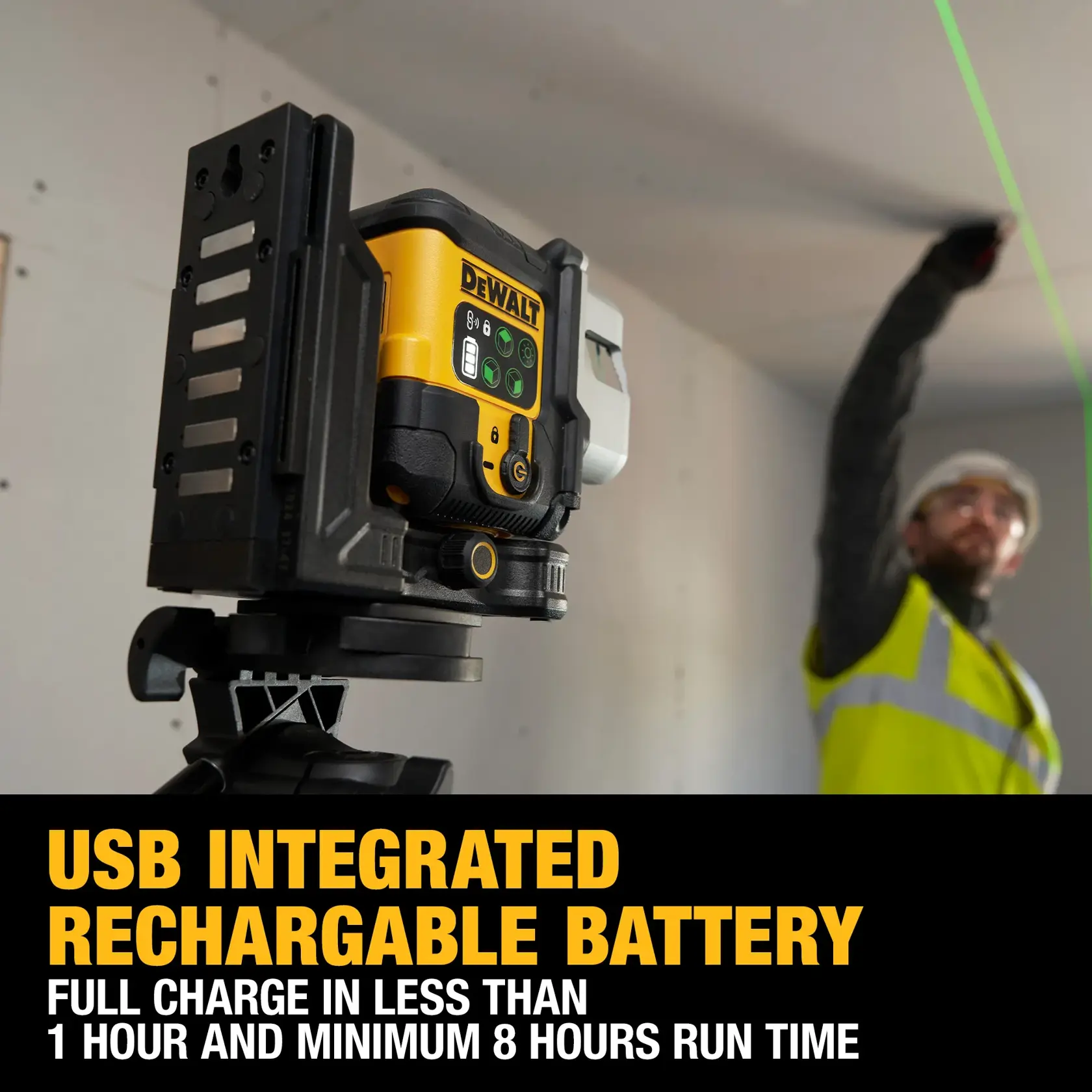 DEWALT laser level on a tripod projecting a green line in a room where cabinets are being installed.