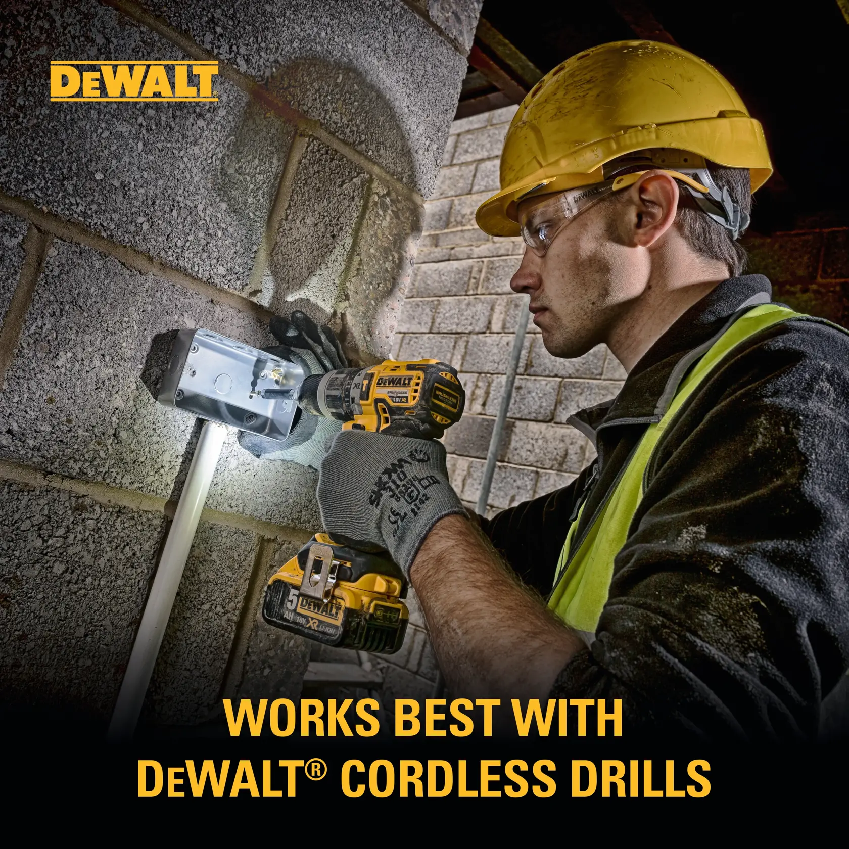 A person wearing a yellow hard hat and gloves is using a DEWALT cordless drill to work on a metal fixture attached to a brick wall. The DEWALT logo is visible in the upper left corner, and text at the bottom reads 'Works best with DEWALT® cordless drills.'