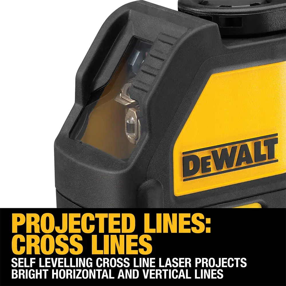 DEWALT green laser level DW088CG on a concrete floor inside a construction site, projecting a straight green line.