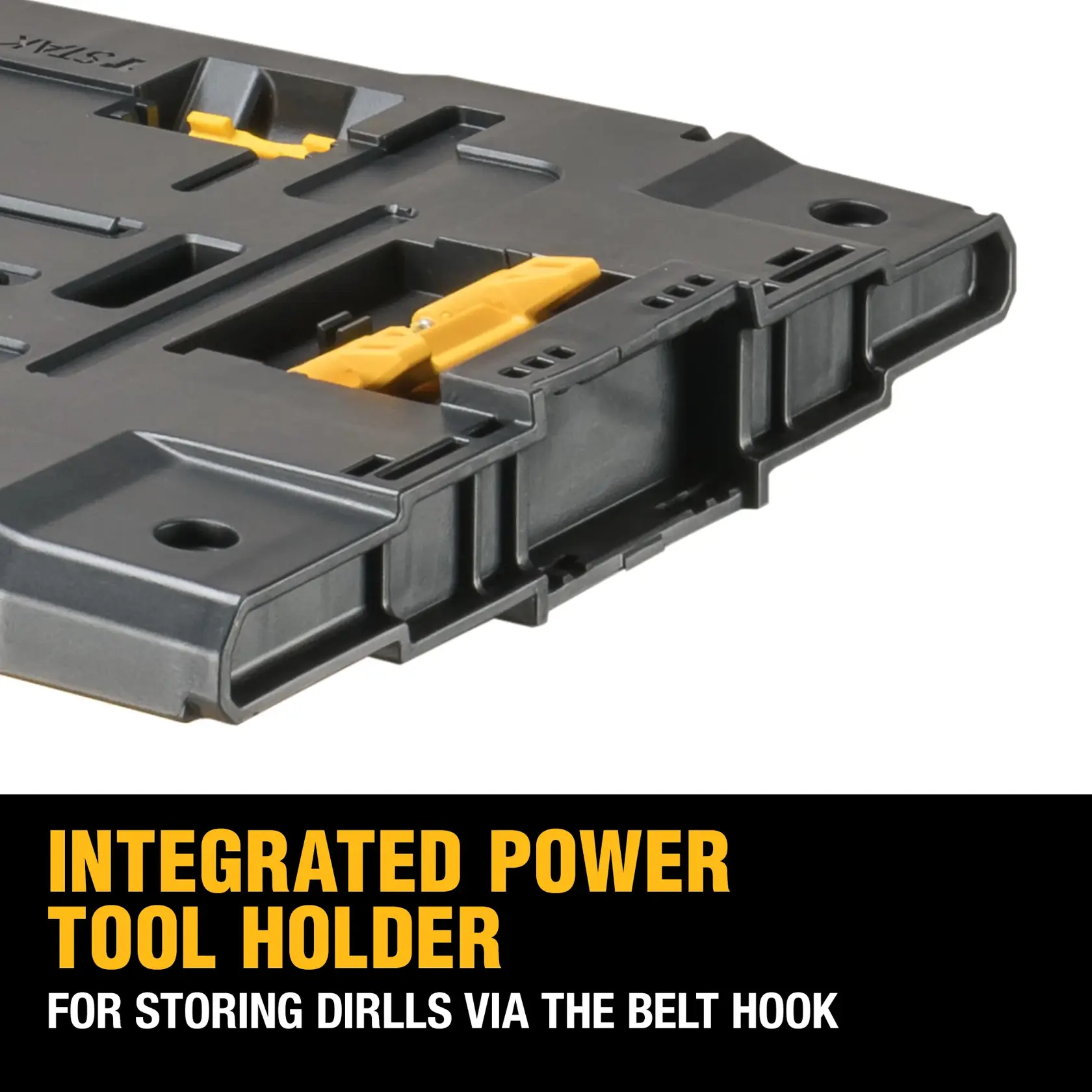 A person on a construction site organizes drill bits and accessories on top of stacked DEWALT ToughSystem 2.0 toolboxes, using a DEWALT power tool.