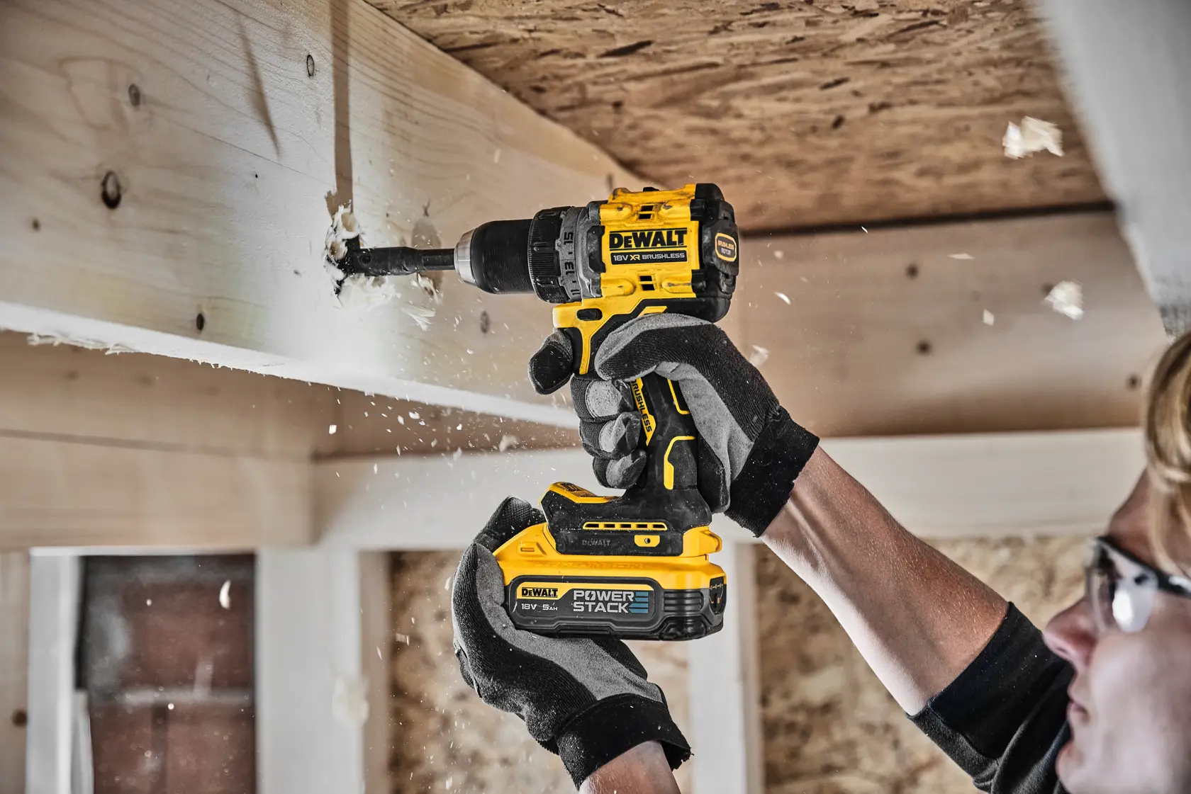 DEWALT 18V XR brushless cordless drill with POWERSTACK battery, black and yellow, side view.