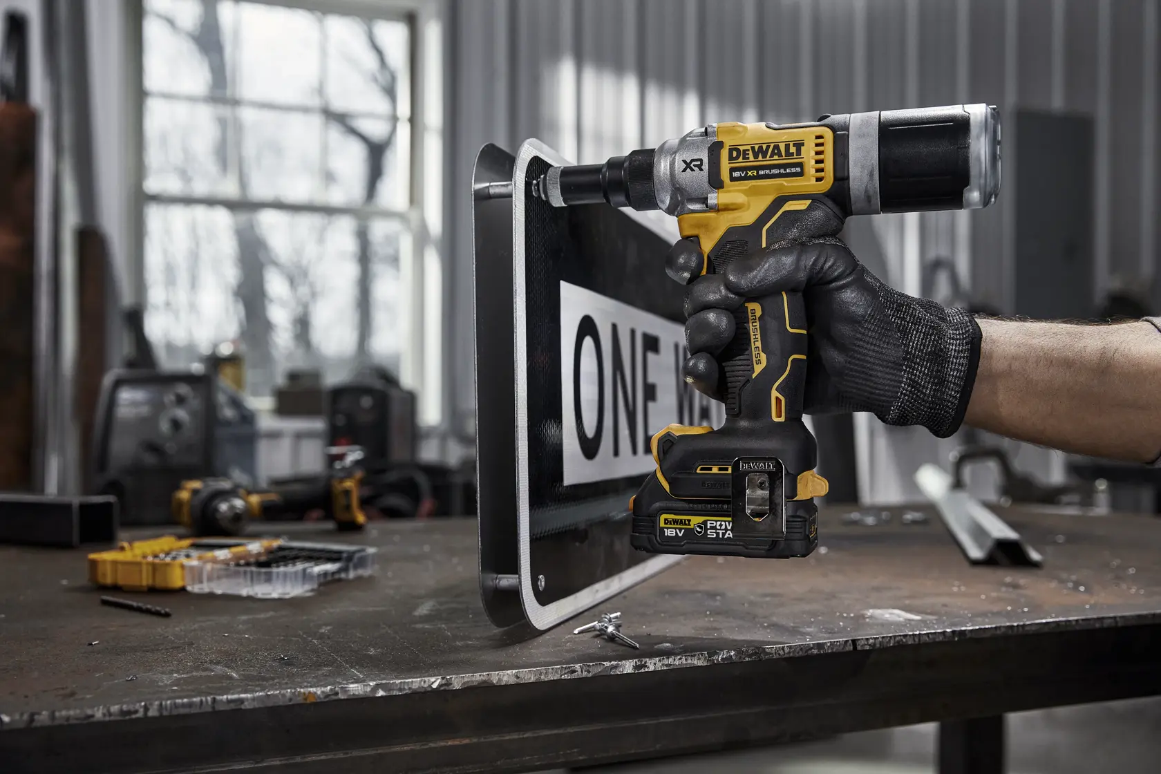 DEWALT cordless yellow and black rivet tool with 18V battery, ergonomic grip, and metal belt clip.