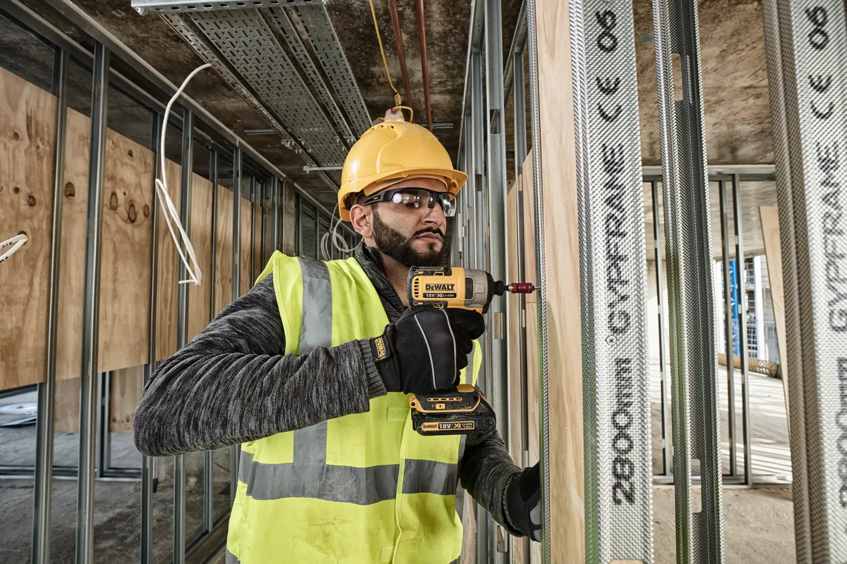 A DEWALT battery and charger are shown inside a large yellow circle with a diagonal line across them, indicating they are not included. Text below reads: 'Battery and charger sold separately.'