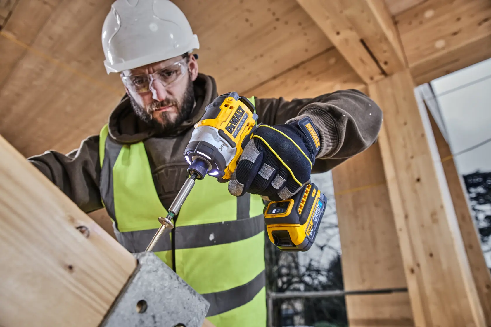 Worker uses DEWALT photography tool. SKUs: DCZ507T2-XE, DCZ407P1T1-XE, DCZ607X2-XE, DCZ503X2-XE, DCF860N.