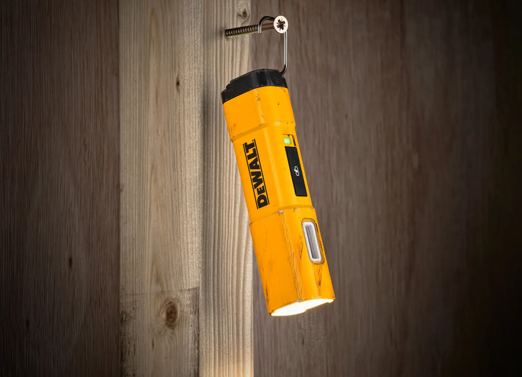A yellow DEWALT DCL183 rechargeable LED flashlight with a rectangular body, side LED panel, and power button.