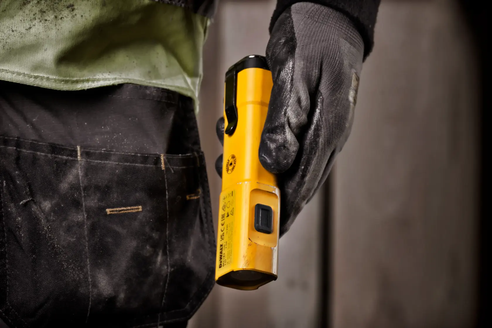 A DEWALT DCL183 yellow LED rechargeable flashlight with a rectangular shape, featuring a side array of LED lights and a power button.