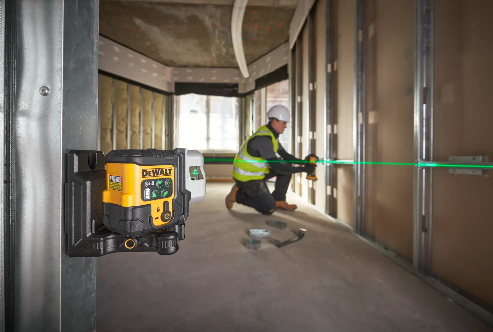 DEWALT laser level kit with a black carrying case, a yellow and black laser level device, a yellow USB cable, and a metal ruler, all displayed together.