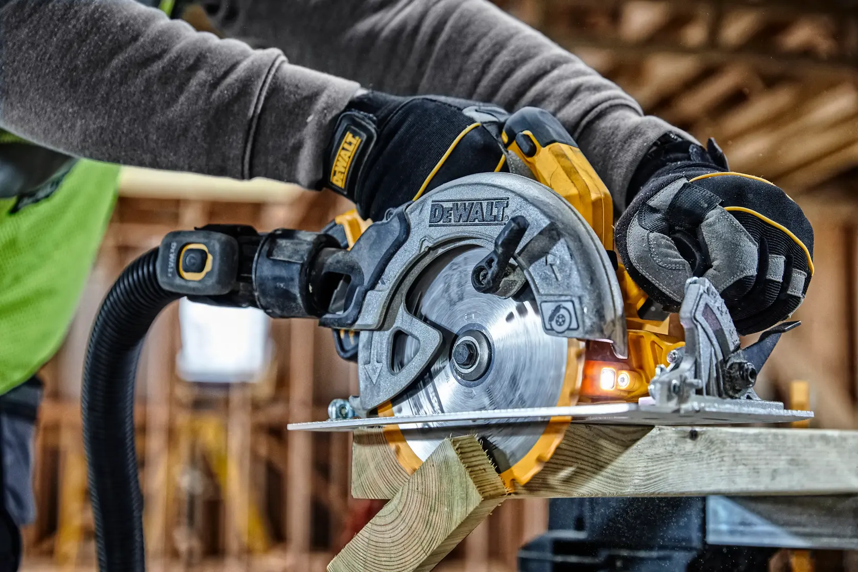 Photo of DEWALT circular saw, SKUs DCS570, DCS570NT-XJ, DCS570NT, cutting wood in construction site.