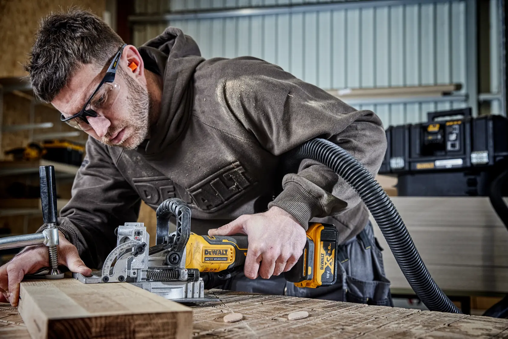 DEWALT jointer DCW682P2-QW, DCW682P2 in use on wood, in workshop. Photography product category.