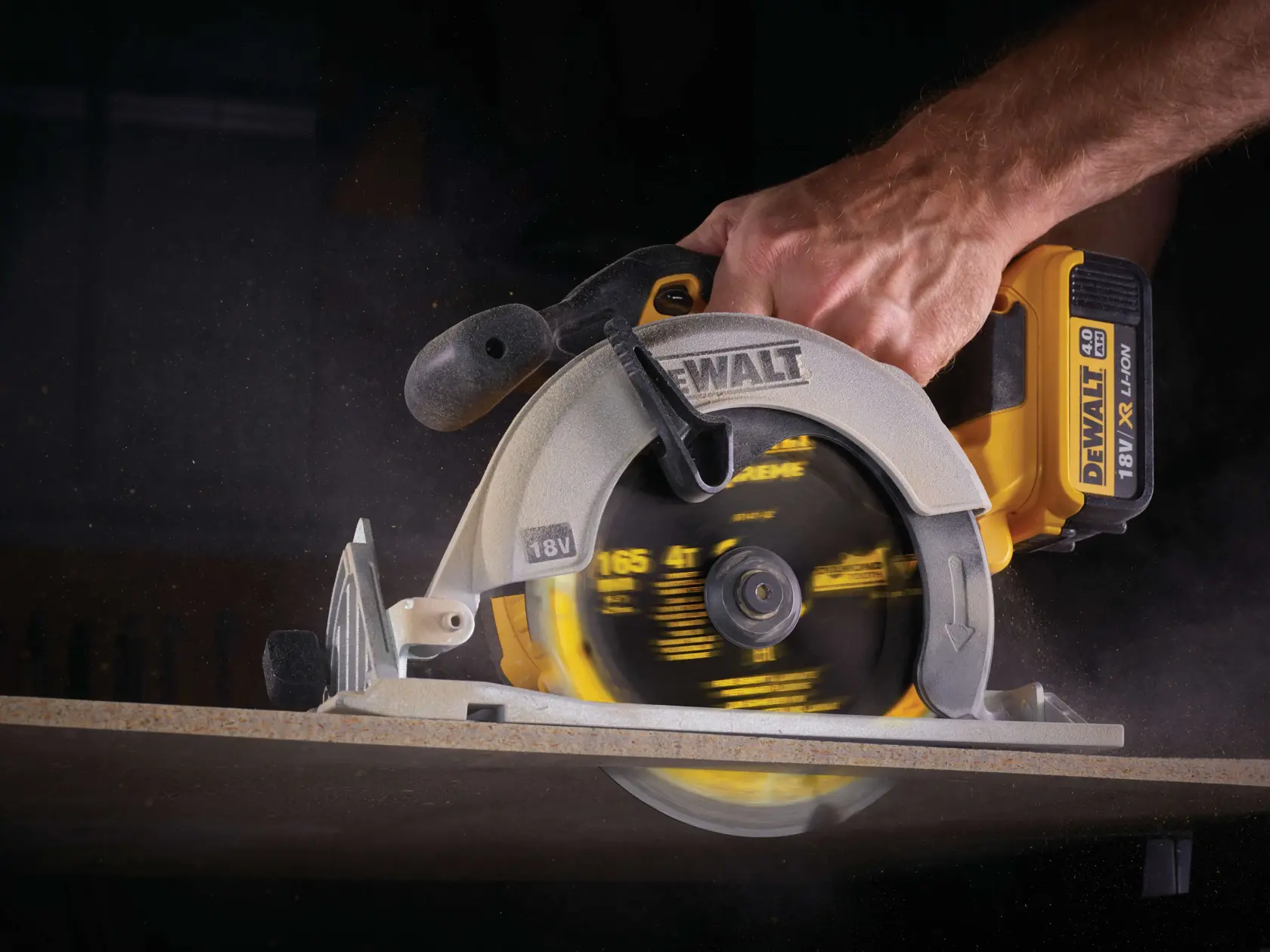 DEWALT cordless circular saw in use, cutting through a wooden board close-up.