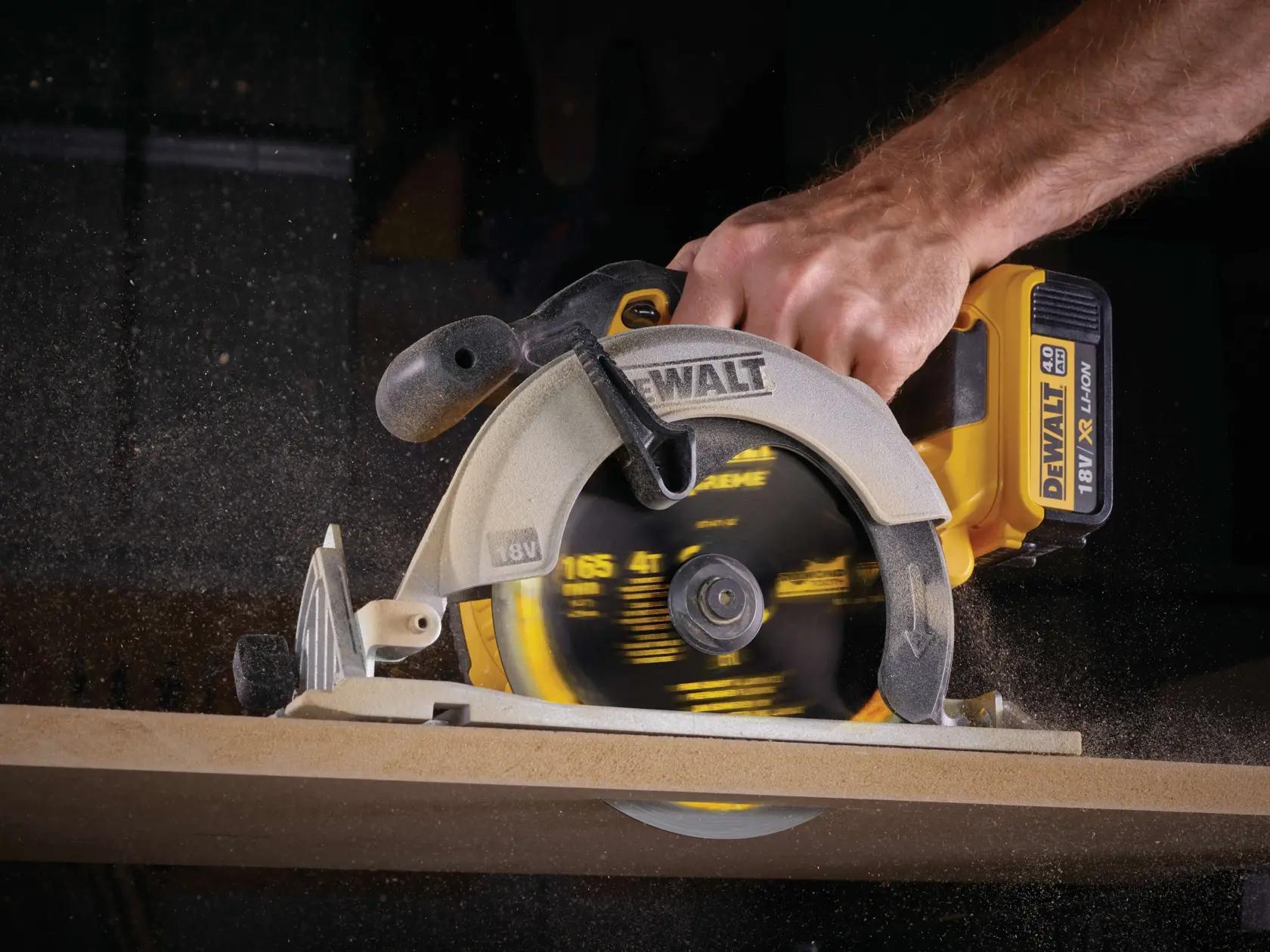 DEWALT cordless circular saw cutting wood, close-up of hand and spinning blade in action.