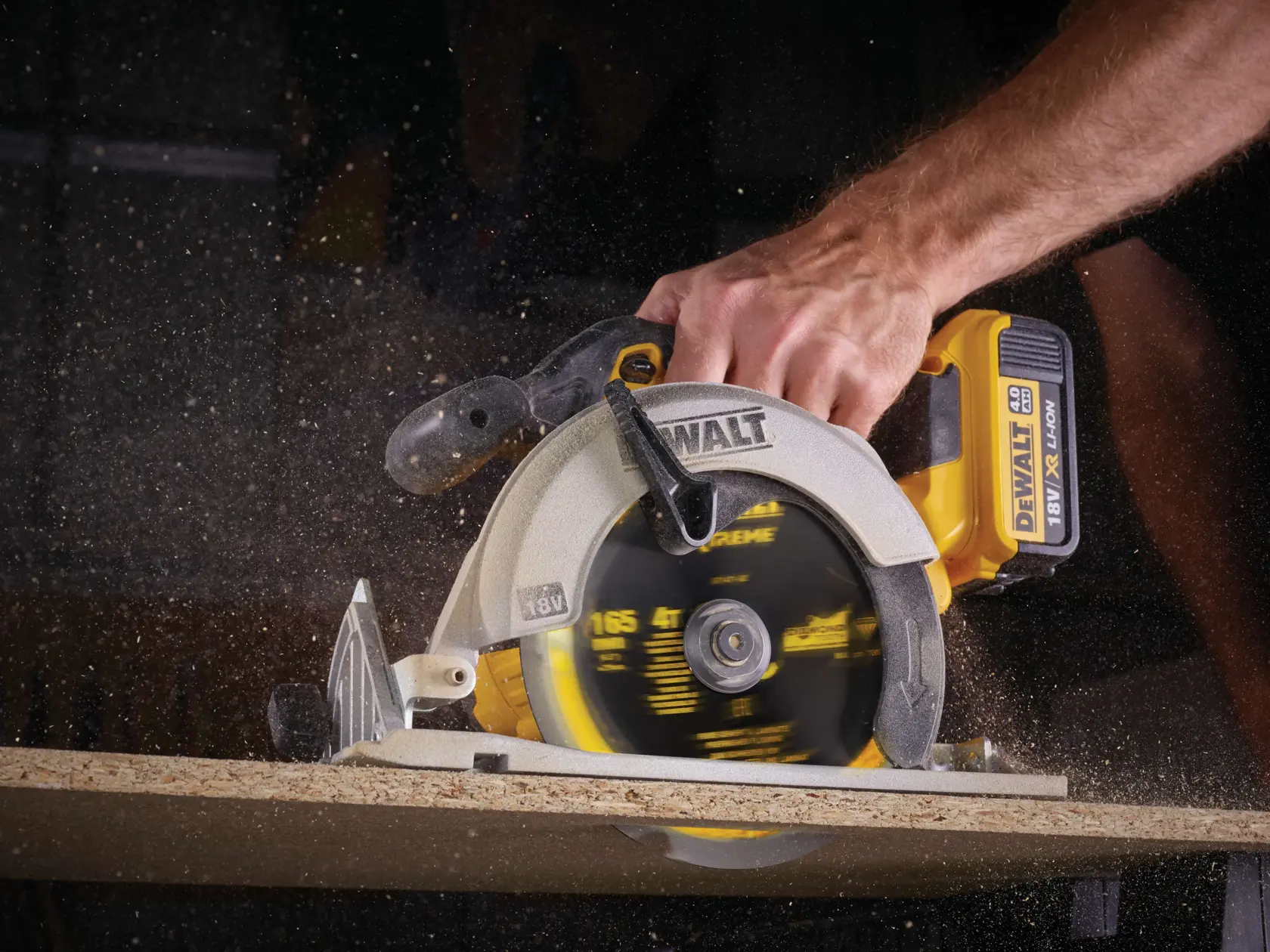 DEWALT cordless circular saw cutting wood with visible sawdust flying.