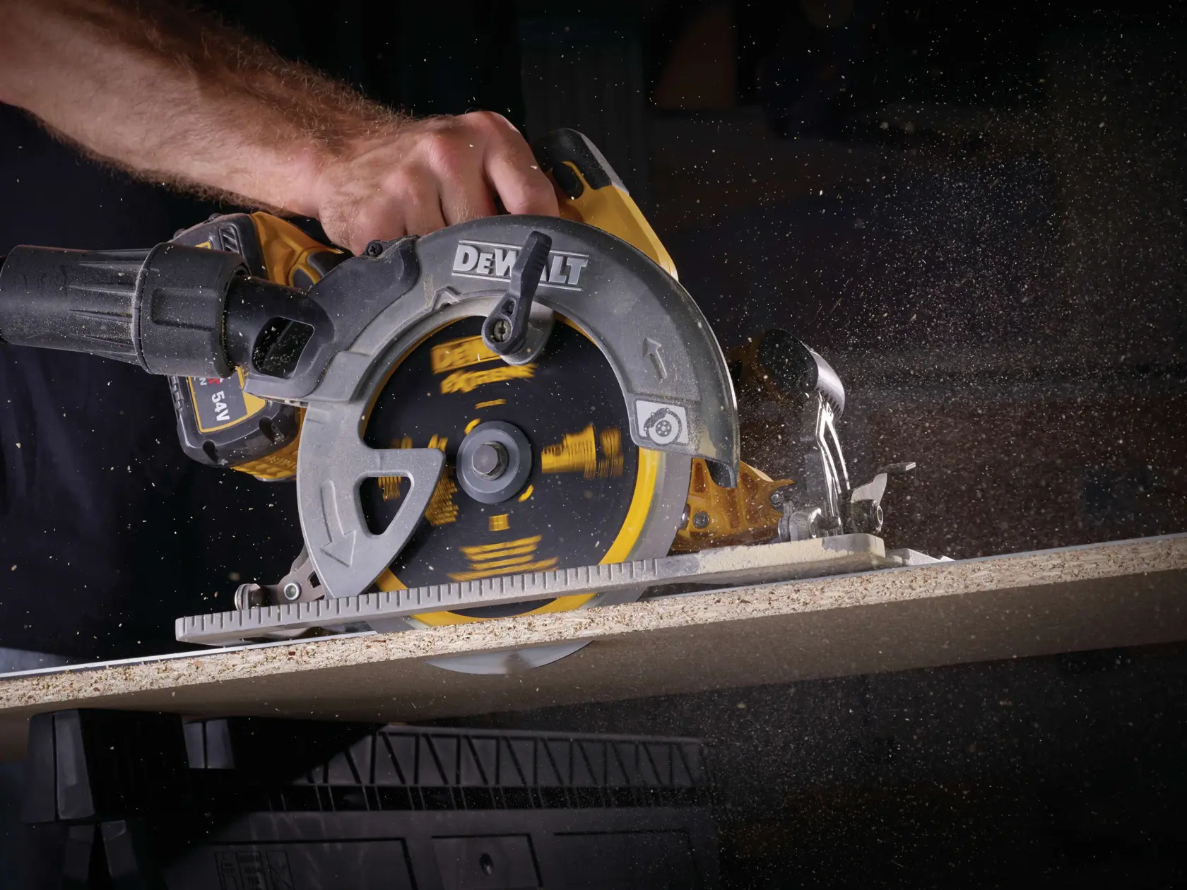 A DEWALT circular saw cutting through wood, with sawdust flying as the blade spins.