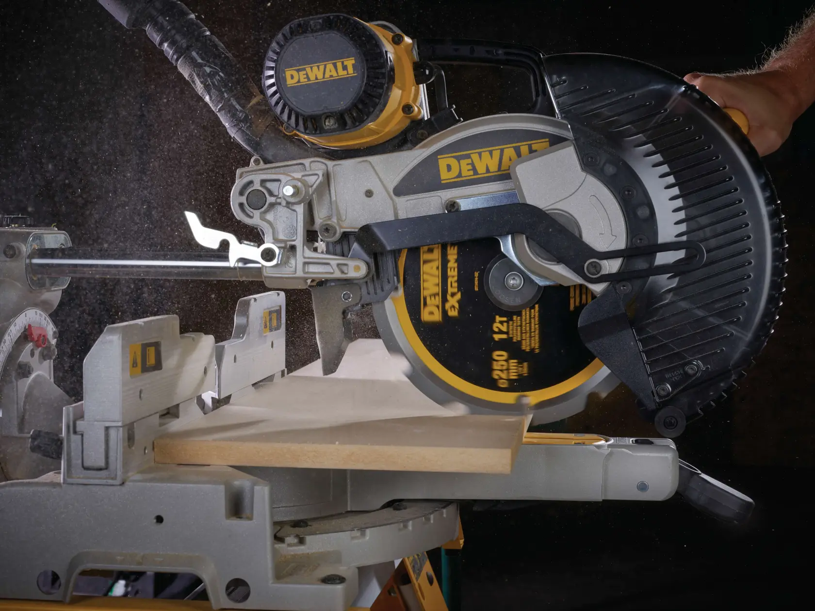 DEWALT circular saw cutting a wooden board with dust visible during operation.