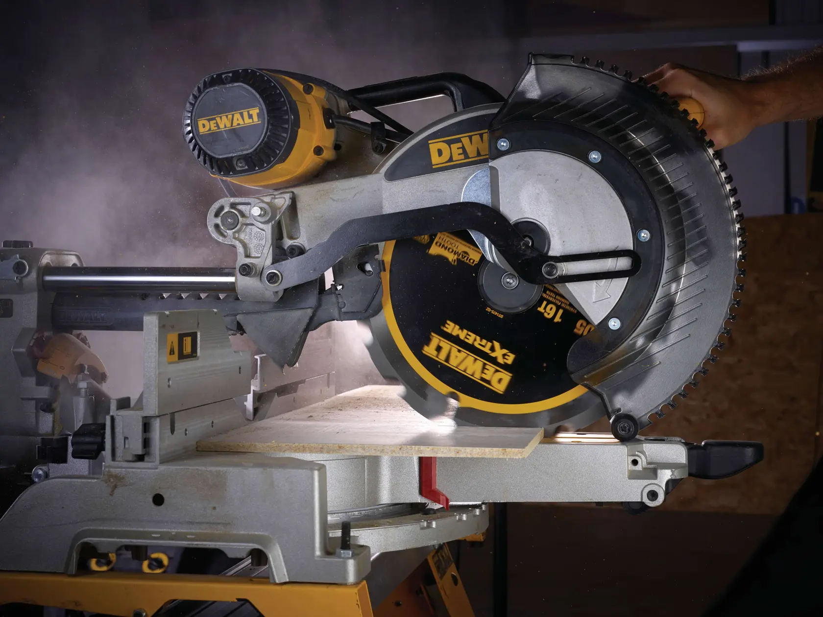 DEWALT circular saw cutting wood, dust visible, close-up of blade and operator hand on handle.