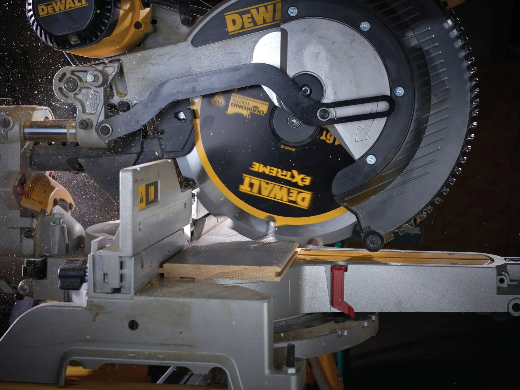 DEWALT circular saw cutting a wooden plank in a workshop, with sawdust flying during operation.