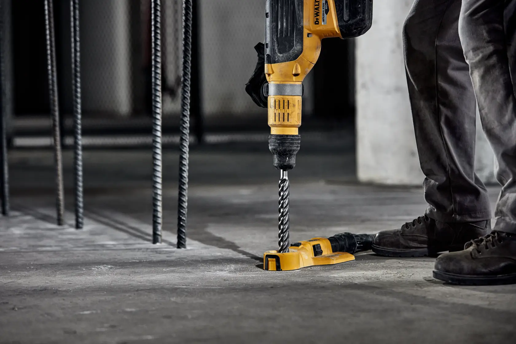 DEWALT DT60829 drill in use on concrete floor, close-up side angle, construction setting.