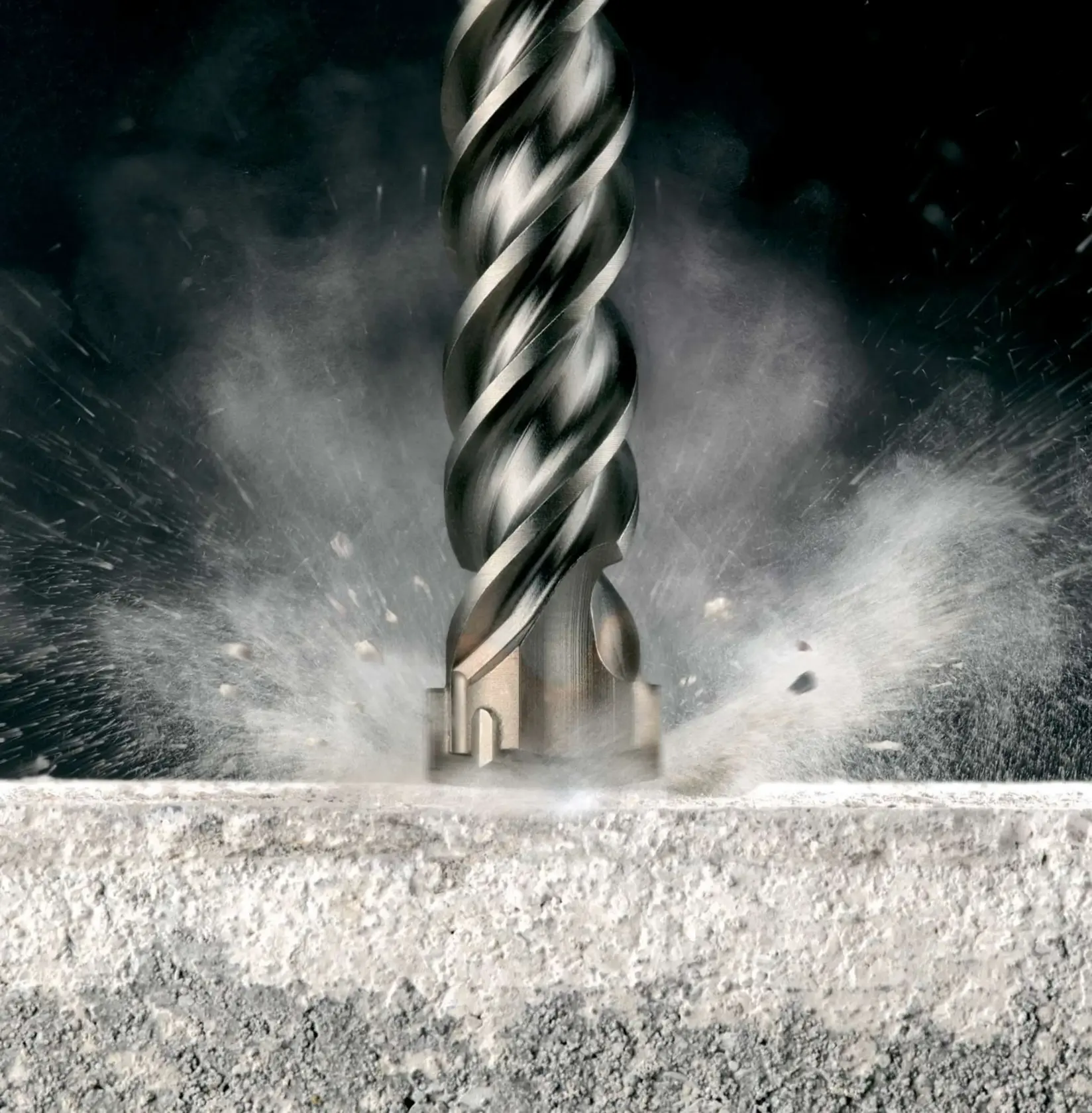 Close-up of a DEWALT drill bit impacting concrete, creating dust and debris.