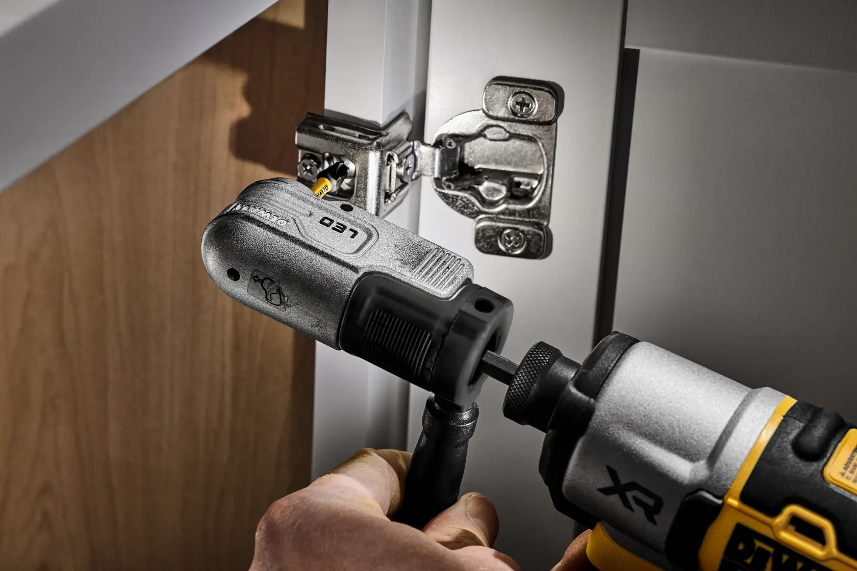 Nahaufnahme eines DEWALT LED-Werkzeugs mit silber-schwarzem Design, Knopf und Bithalter sichtbar.