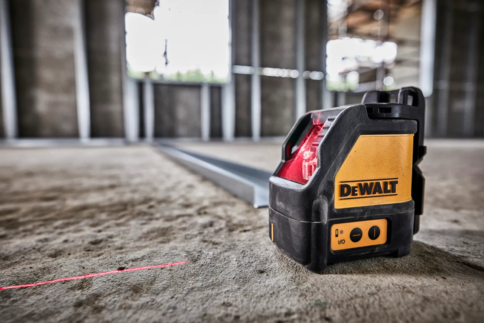 DEWALT DW088K cross line laser level kit, including a black carrying case with DEWALT logo, two yellow batteries, the laser level device, and a black mounting bracket.