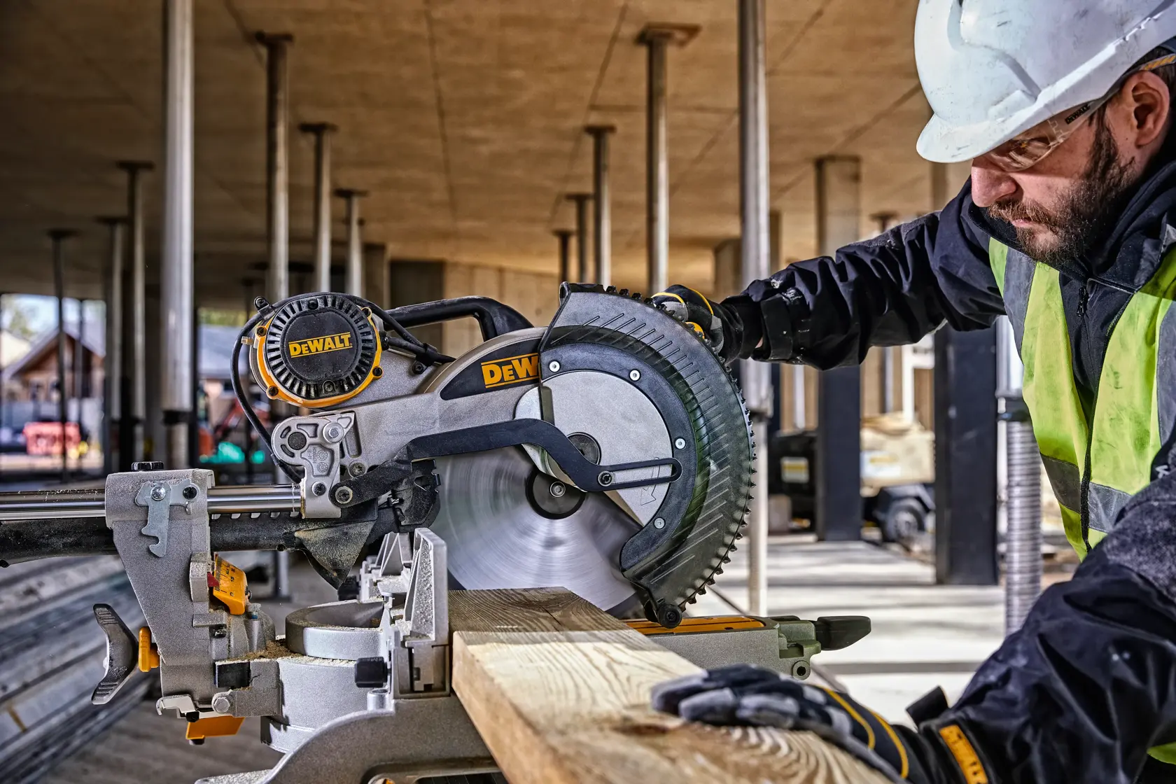 DEWALT DWS780, DWS780KIT miter saw used by worker cutting wood at construction site. Photography category.