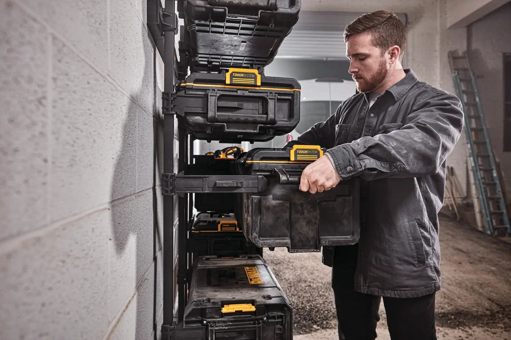 DEWALT ToughSystem 2.0 promotional graphic with the slogan 'Storage Built to Handle It' in large, bold yellow lettering on a dark, textured background.