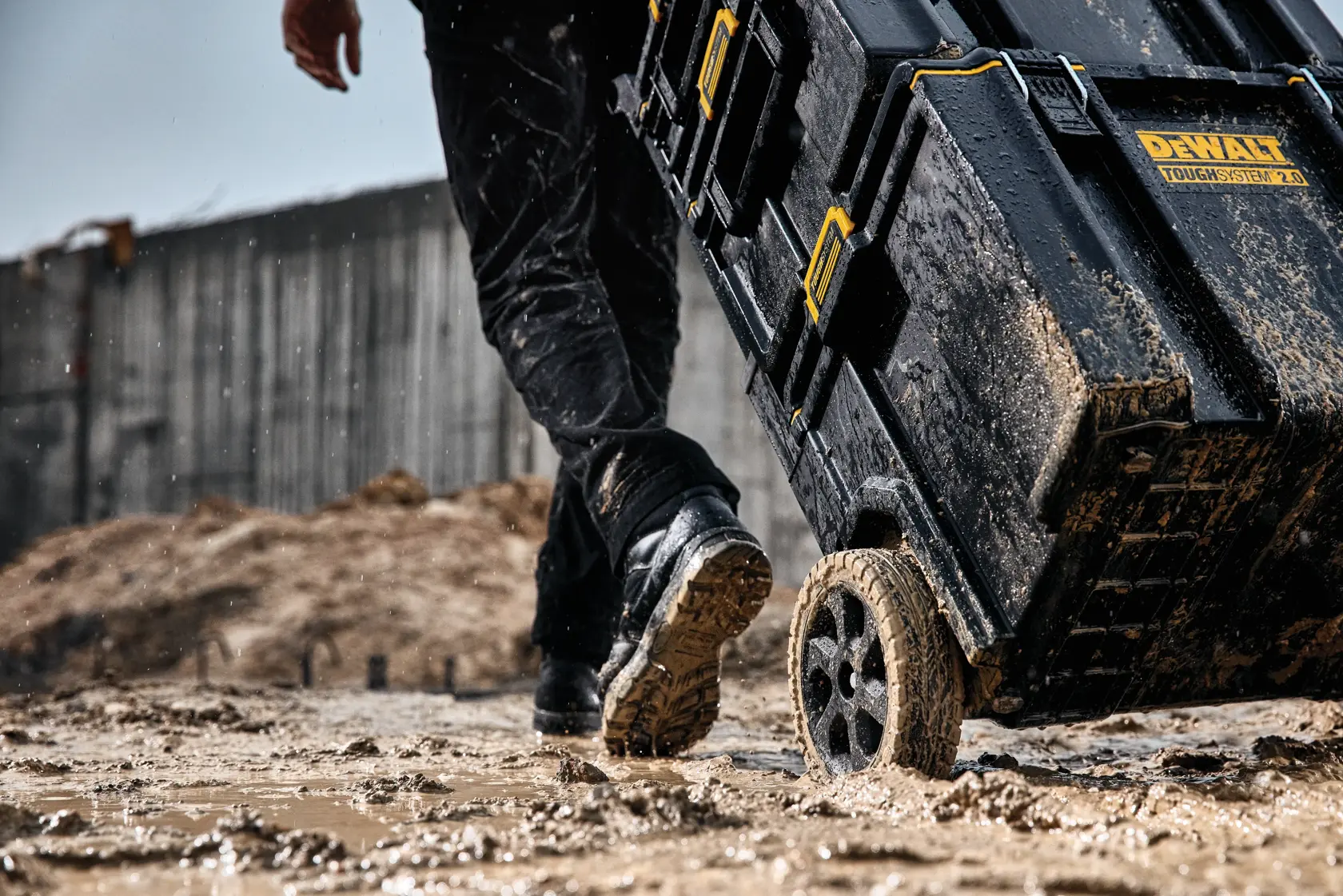 DEWALT ToughSystem 2.0 promotional graphic with the slogan 'Storage Built to Handle It' in large, bold yellow lettering on a dark, textured background.